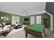 Entertainment space features a pool table, TV, comfortable seating, and a ceiling fan at 2001 Carrington Dr, Raleigh, NC 27615