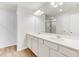 This primary bathroom features double sinks, granite countertops, a large mirror and a walk-in shower at 2004 Regal Dr # 86, Durham, NC 27703