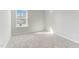 Bright bedroom with plush carpeting, a large window, and freshly painted walls at 2004 Regal Dr # 86, Durham, NC 27703