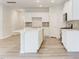 Bright kitchen features a spacious island, white cabinets, and modern stainless steel appliances at 2004 Regal Dr # 86, Durham, NC 27703