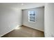 A single window brightens this basic empty bedroom with neutral carpeting at 2005 Silent Bend Dr, Durham, NC 27704