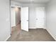This empty bedroom offers neutral carpeting and two doors leading to other rooms at 2005 Silent Bend Dr, Durham, NC 27704