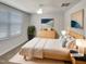 This staged bedroom features neutral tones and a light wood bedframe and dresser at 2005 Silent Bend Dr, Durham, NC 27704