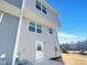 The exterior corner of the home features light gray siding and white trim with a back door at 2005 Silent Bend Dr, Durham, NC 27704