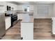 The kitchen has white cabinetry, stainless appliances, and speckled granite countertops at 2005 Silent Bend Dr, Durham, NC 27704