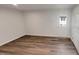 Bright living room featuring hardwood floors, a door to the outside, and neutral colored walls at 2005 Silent Bend Dr, Durham, NC 27704