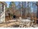 Backyard deck featuring a dining table with seating and stairs to the yard, ideal for outdoor meals at 201 Sea Biscuit Lane, Apex, NC 27539