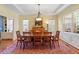 Bright dining room with a large wooden table, chairs, and plenty of natural light at 201 Sea Biscuit Lane, Apex, NC 27539