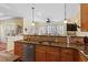 Kitchen area featuring granite countertops, stainless steel dishwasher, and stylish pendant lighting at 201 Sea Biscuit Lane, Apex, NC 27539