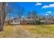 Classic brick home with manicured lawn, showcasing traditional design and curb appeal on a sunny day at 203 Oakgrove Dr, Graham, NC 27253