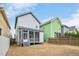 Backyard view of a gray two-story home with a screened porch, grass and blue sky at 2098 Great Ridge Pkwy, Chapel Hill, NC 27516