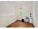 Bright bedroom with hardwood floors, white built-in storage, desk, and a chair at 2098 Great Ridge Pkwy, Chapel Hill, NC 27516