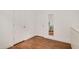 Bedroom featuring hardwood floors, white walls, doors and a glimpse of desk set reflected in a mirror at 2098 Great Ridge Pkwy, Chapel Hill, NC 27516