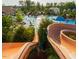 Water slides empty into the community pool, which is surrounded by lounge chairs and tropical plants at 2098 Great Ridge Pkwy, Chapel Hill, NC 27516