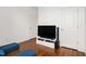 Living room with hardwood floors, a TV, and blue ottomans at 2098 Great Ridge Pkwy, Chapel Hill, NC 27516