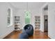 Bright living room featuring hardwood floors, built-in bookcases, and stylish seating at 2098 Great Ridge Pkwy, Chapel Hill, NC 27516