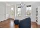 Bright living room featuring hardwood floors, large windows, modern furniture, and stylish chandelier at 2098 Great Ridge Pkwy, Chapel Hill, NC 27516
