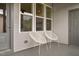 Covered front patio with three large windows and modern chairs at 2098 Great Ridge Pkwy, Chapel Hill, NC 27516