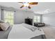 Bright bedroom with a ceiling fan, neutral carpet, and a comfortable seating area at 211 Candia Ln, Cary, NC 27519