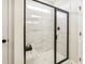 Modern bathroom shower with marble-like tile, glass door, and a built-in bench at 219 E American Merigold Dr # 45, Benson, NC 27504
