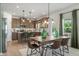 Bright dining area adjacent to the kitchen featuring a modern table setting and lots of natural light at 219 E American Merigold Dr # 45, Benson, NC 27504