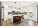 Well-lit kitchen featuring white cabinets, stainless steel appliances, and a central island with seating at 219 E American Merigold Dr # 45, Benson, NC 27504