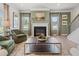Elegant living room with a fireplace, comfortable seating, and windows showcasing a lovely view at 219 E American Merigold Dr # 45, Benson, NC 27504