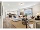 Spacious living room with a large white sofa, hardwood floors, and an open view to the kitchen at 219 E American Merigold Dr # 45, Benson, NC 27504