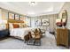 Elegant primary bedroom featuring a tray ceiling, neutral decor, and a spacious layout at 219 E American Merigold Dr # 45, Benson, NC 27504
