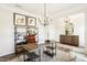 Home office with modern chandelier, wood floors, built in shelves, and large desk space at 219 E American Merigold Dr # 45, Benson, NC 27504