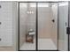 Modern walk-in shower with sleek black hardware, tiled walls, and a built-in seat at 219 E American Merigold Dr # 45, Benson, NC 27504
