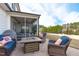 Outdoor patio area with a fire pit, grill, lounge seating and view of the screened porch at 2534 Great Daisy Ln, New Hill, NC 27562