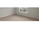 Bedroom showing neutral walls, carpeted floors, and a window providing natural light and neighborhood views at 257 Umstead St, Sanford, NC 27330