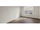 Bright bedroom showcasing wood-look floors, neutral walls and a window overlooking the neighborhood at 257 Umstead St, Sanford, NC 27330