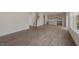 Spacious open floor plan with wood-look floors, staircase, and a view into the modern kitchen at 257 Umstead St, Sanford, NC 27330