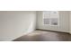 Bedroom with wood-look flooring and a window providing natural light and neighborhood views at 273 Umstead St, Sanford, NC 27330