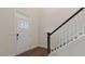 Inviting entryway featuring a staircase with white banisters, a modern front door, and hardwood flooring at 277 Umstead St, Sanford, NC 27330