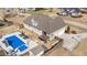 Aerial view of the property showcasing the home, pool area, grilling area, and a large backyard with fence at 29 Alban Row, Fuquay Varina, NC 27526