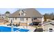 Backyard view featuring a pool, lounge chairs, grilling area, and an outdoor gazebo, ideal for outdoor living at 29 Alban Row, Fuquay Varina, NC 27526