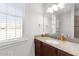 Bathroom featuring a granite vanity, mirror, and natural light from the window at 29 Alban Row, Fuquay Varina, NC 27526