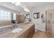 Bright bathroom featuring double sinks, granite countertops, and a separate tub and shower at 29 Alban Row, Fuquay Varina, NC 27526
