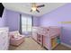 This bedroom has a ceiling fan and light-filled window at 29 Alban Row, Fuquay Varina, NC 27526