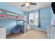 This bedroom has a ceiling fan and light-filled window at 29 Alban Row, Fuquay Varina, NC 27526