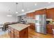Spacious kitchen with island, stainless appliances, and connection to the living area at 29 Alban Row, Fuquay Varina, NC 27526