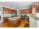 Modern kitchen with stainless steel appliances, a granite island, and wooden cabinetry at 29 Alban Row, Fuquay Varina, NC 27526