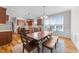 Bright kitchen and dining area featuring a large window, hardwood floors, and stylish decor at 29 Alban Row, Fuquay Varina, NC 27526