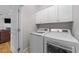 Laundry room with white cabinets and modern appliances at 29 Alban Row, Fuquay Varina, NC 27526