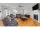 Comfortable living room with a fireplace, hardwood floors, and two windows at 29 Alban Row, Fuquay Varina, NC 27526