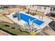 Backyard features a pool with a slide, lounge chairs, and an outdoor dining area, perfect for relaxation and entertainment at 29 Alban Row, Fuquay Varina, NC 27526