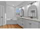 Bright bathroom with double sink vanity, a soaking tub, hardwood floors, and a large window at 2955 Mt Pleasant Rd, Willow Springs, NC 27592